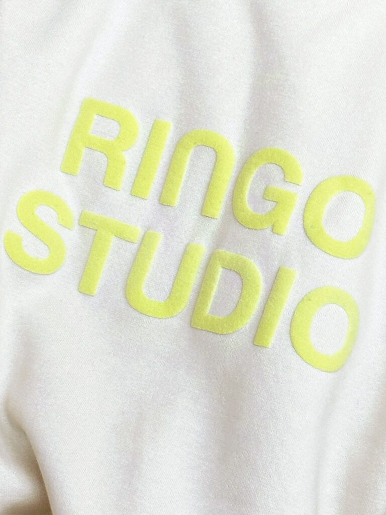 Ringo Studio puff-print detail on beige sweatshirt.