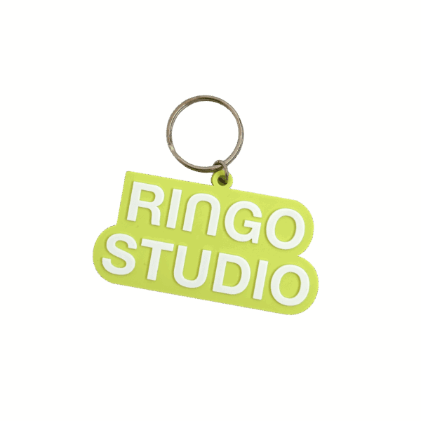 3” Ringo Studio lime green keychain with white letters.