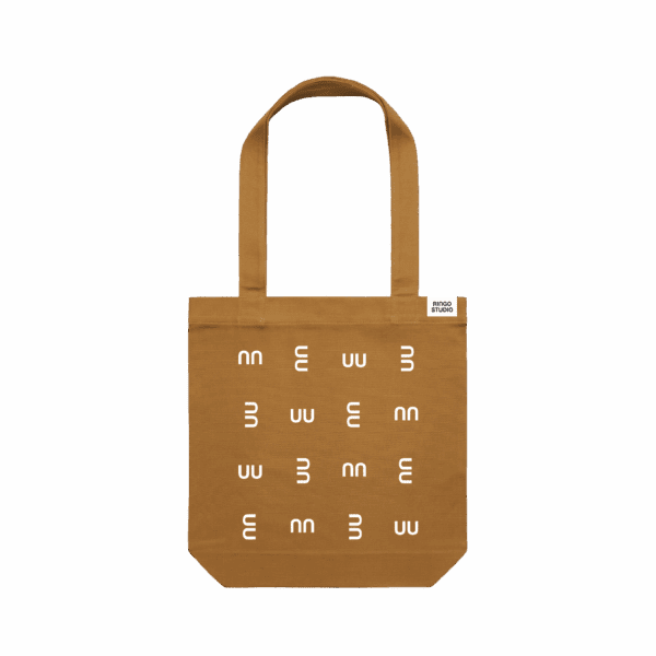 Ringo Studio’s one compartment tote bag in tan colour with Ringo Studio monogram as textured pattern. Ringo Studio logo tag sewed on the edge.